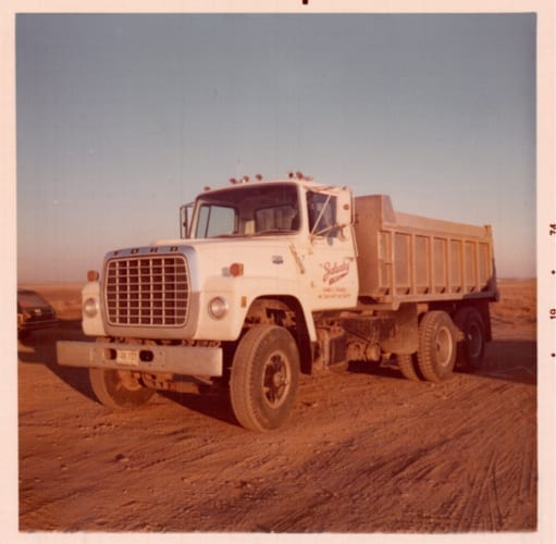 A grainy photo of a Zalusky branded dump truck
